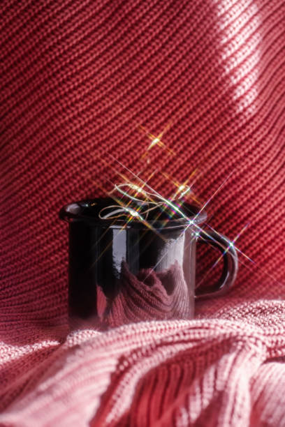istock A mug with lights stands on a pink knitted background. 1356901896