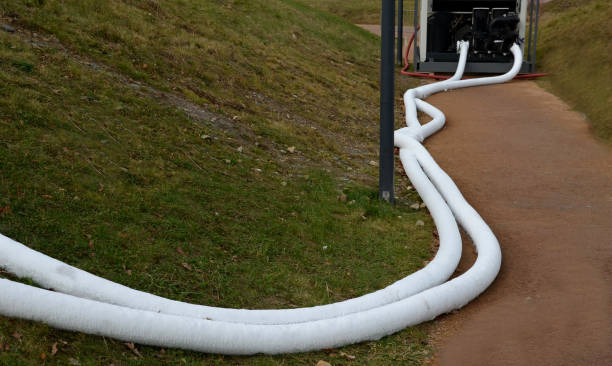 cooling register of pipes under the ice surface. rows of frozen tubes. strong pipes, hoses are twisted on the lawn in the park. A portable cooling device stands nearby and cools the coolant mixture, aggregate, geotextile, nhl winter classic, wall, switchboard, commutator registro de enfriamiento de tuberías debajo de la superficie de hielo. filas de tubos congelados. tuberías fuertes, mangueras se retuercen en el césped del parque. un dispositivo de enfriamiento portátil se encuentra cerca y enfría la mezcla de refrig