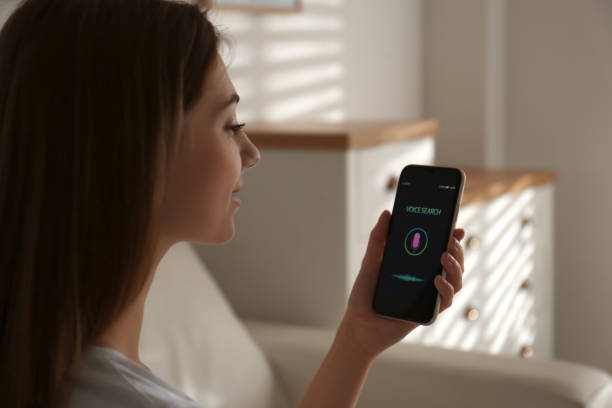istock Woman using voice search on smartphone indoors 1356907080