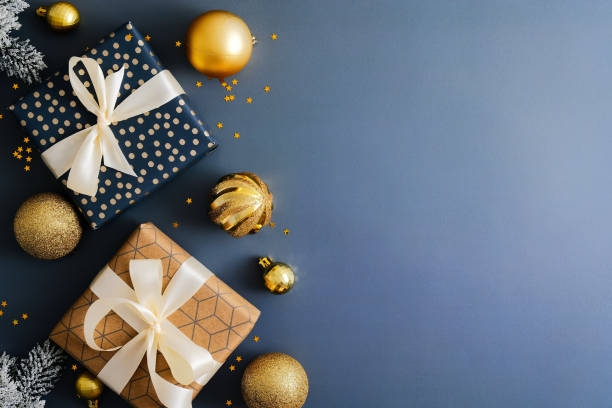istock Dark blue Christmas background with gift boxes and gold baubles. Flat lay, top view, copy space. Merry Christmas and Happy New Year greeting card design. 1356907395