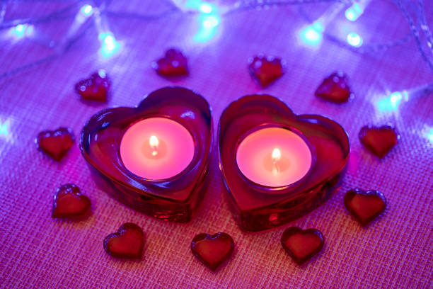 istock Our hearts burn together!!! Two heart shaped candles - Valentine's day concept 1356908183