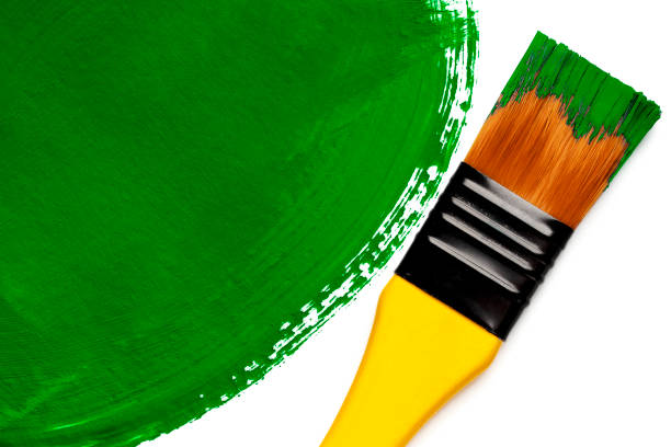istock Paintbrush with green painted spot (isolated on white) 1356908401