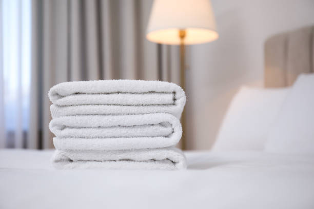 Towels roll on the bed at the hotel.