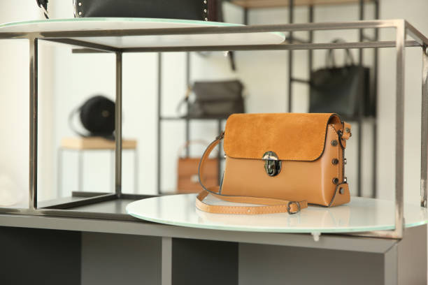 istock Stylish woman's bag on stand in boutique 1356918685
