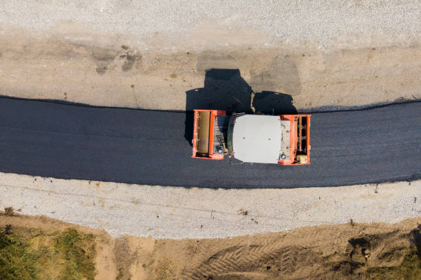 istock Aerial view of new road construction with steam roller machine at work. 1356918728