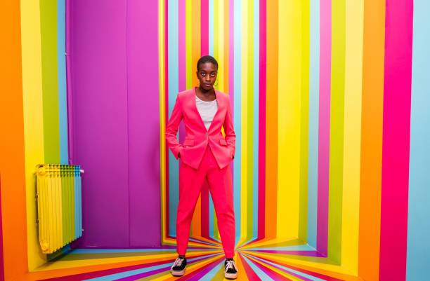 istock Beautiful young woman dancing and having fun inside a rainbow box room 1356919052