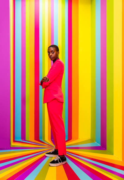 istock Beautiful young woman dancing and having fun inside a rainbow box room 1356919070