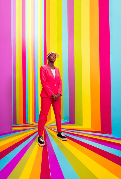 istock Beautiful young woman dancing and having fun inside a rainbow box room 1356919090