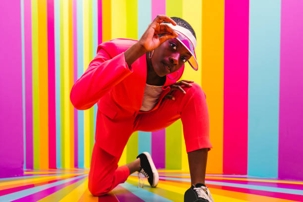 istock Beautiful young woman dancing and having fun inside a rainbow box room 1356919662