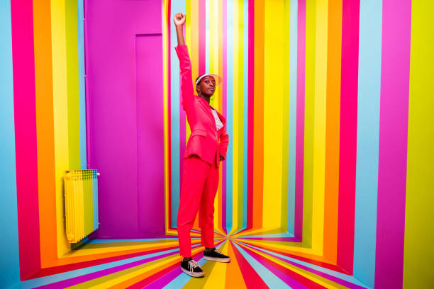 istock Beautiful young woman dancing and having fun inside a rainbow box room 1356919681
