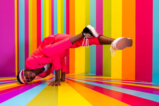 istock Beautiful young woman dancing and having fun inside a rainbow box room 1356919704