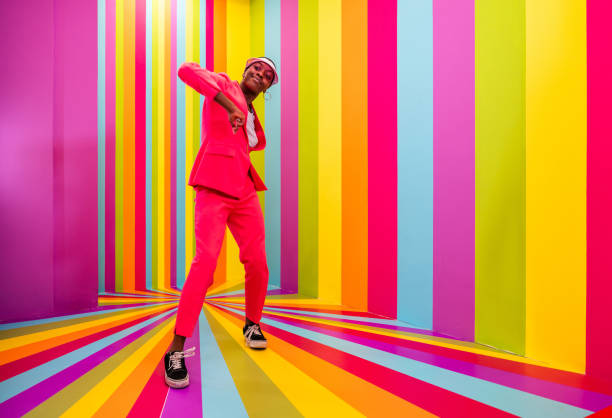 istock Beautiful young woman dancing and having fun inside a rainbow box room 1356919719