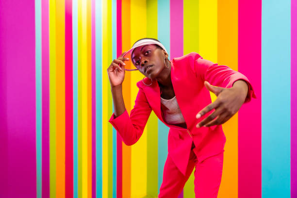 istock Beautiful young woman dancing and having fun inside a rainbow box room 1356919747