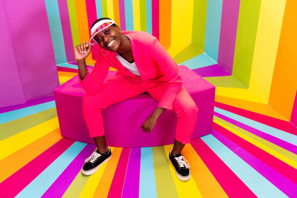 istock Beautiful young woman dancing and having fun inside a rainbow box room 1356919846