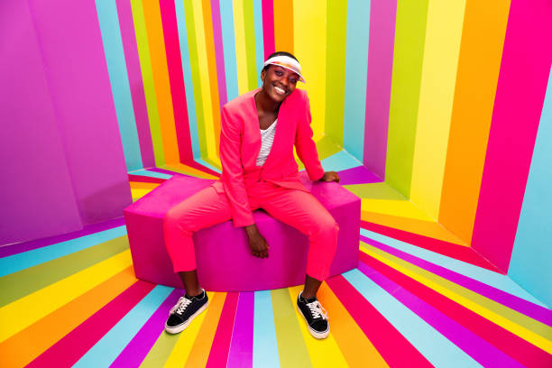 istock Beautiful young woman dancing and having fun inside a rainbow box room 1356919897