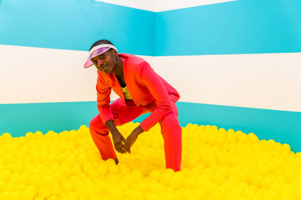 istock Beautiful young woman posing and having fun inside a rainbow box room 1356919918