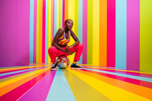 istock Beautiful young woman dancing and having fun inside a rainbow box room 1356920037