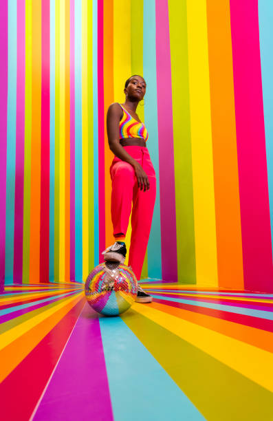 istock Beautiful young woman dancing and having fun inside a rainbow box room 1356920123