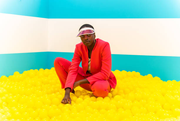 istock Beautiful young woman posing and having fun inside a rainbow box room 1356920212