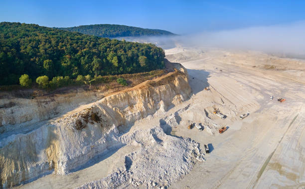 istock Aerial view of open pit mining of limestone materials for construction industry with excavators and dump trucks. 1356921268