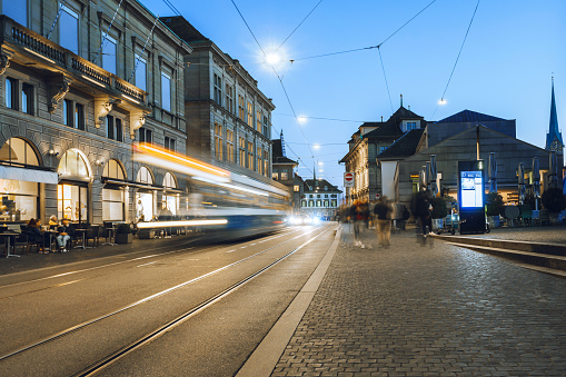 tram in zurich old town at sunset hour