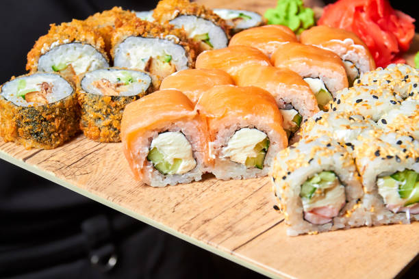 istock Set of various sushi rolls on a board. Close-up, selective focus 1356922170