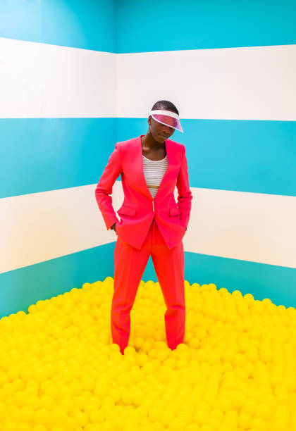 istock Beautiful young woman posing and having fun inside a rainbow box room 1356922249