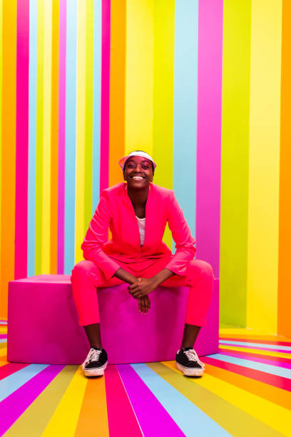 istock Beautiful young woman dancing and having fun inside a rainbow box room 1356922264