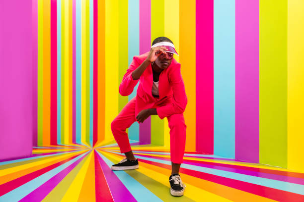 istock Beautiful young woman dancing and having fun inside a rainbow box room 1356922270