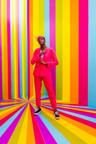istock Beautiful young woman dancing and having fun inside a rainbow box room 1356922295