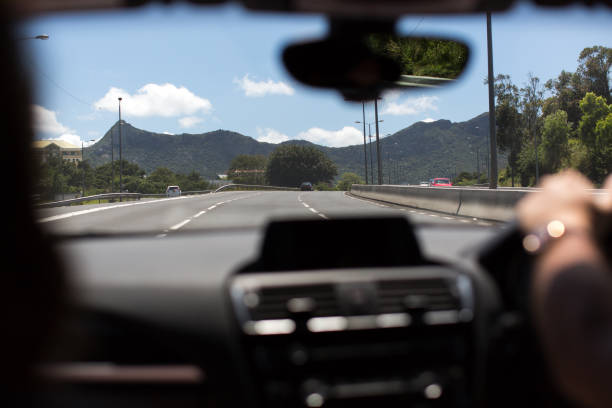 istock Young man driving on the road 1356922505