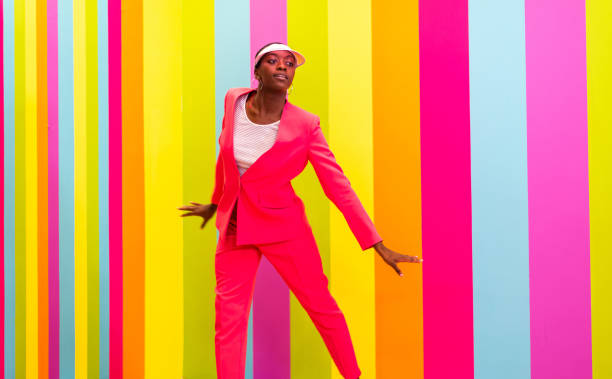 istock Beautiful young woman dancing and having fun inside a rainbow box room 1356923333