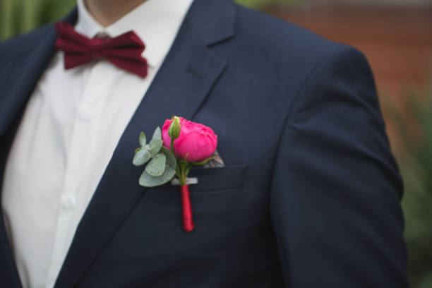 istock Red rose boutonniere on groom's suit 1356923349