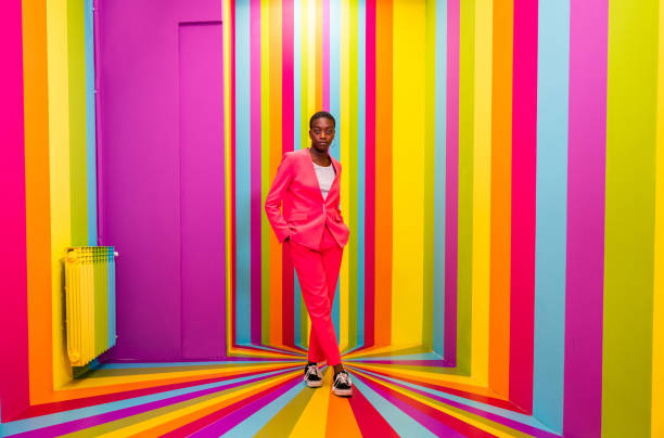 istock Beautiful young woman dancing and having fun inside a rainbow box room 1356923465