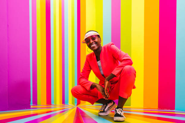 istock Beautiful young woman dancing and having fun inside a rainbow box room 1356923496