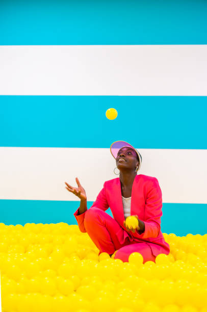 istock Beautiful young woman posing and having fun inside a rainbow box room 1356923518