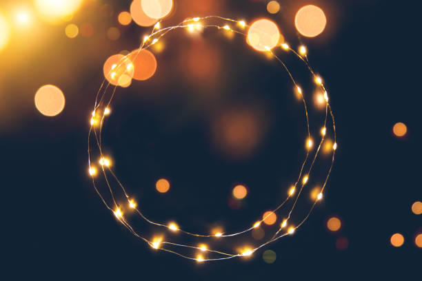 istock Defocused light background with circular light garland and copy space for your text 1356925759