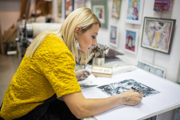 istock In her art studio, creative female artist drawing with ink 1356928128