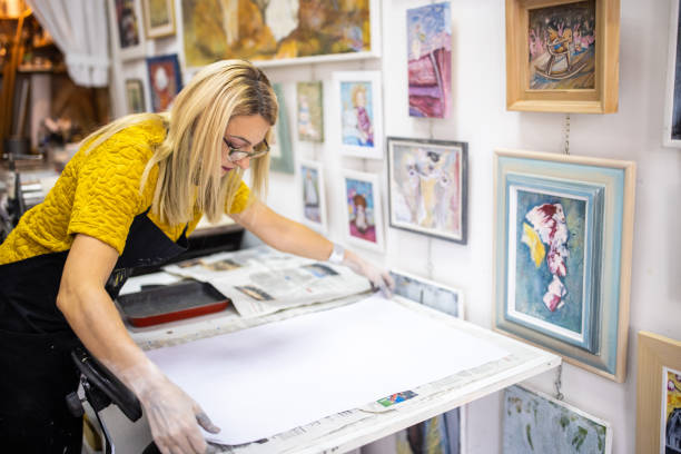 istock In her art studio, female craft persn adjusting paper for printmaking technique 1356928205