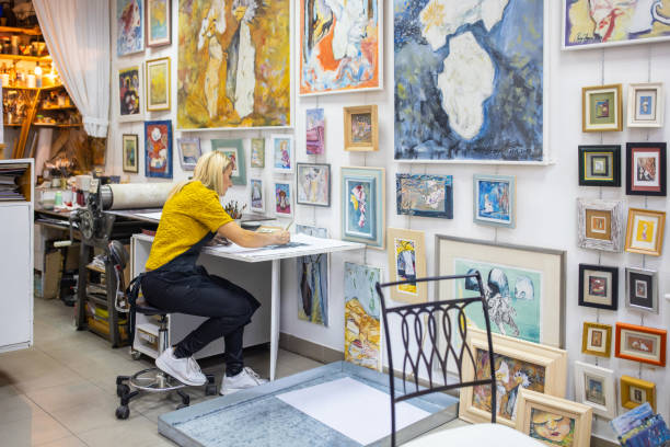 istock From her modern art workshop,female lithography artist working on anew art 1356928610