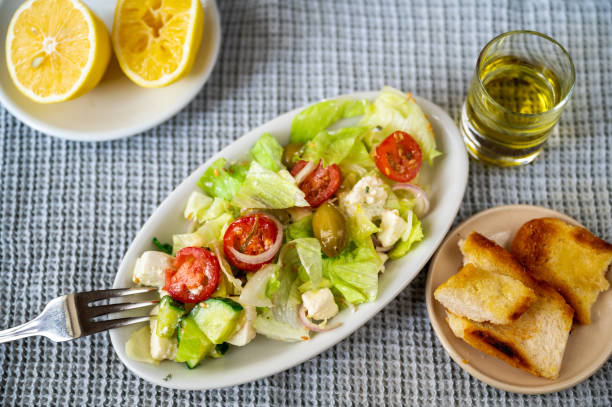 istock Plate with salad, pastry, olive oil and lemon 1356928634