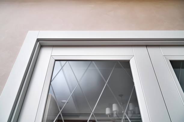 istock Stylish door with mirror glass and reflected luster in room 1356928647
