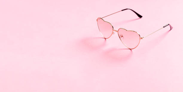 istock Heart shape sunglasses on pink background 1356929015