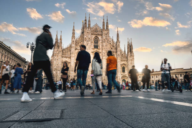 Duomo square in Milan crowded at sunset stock photo