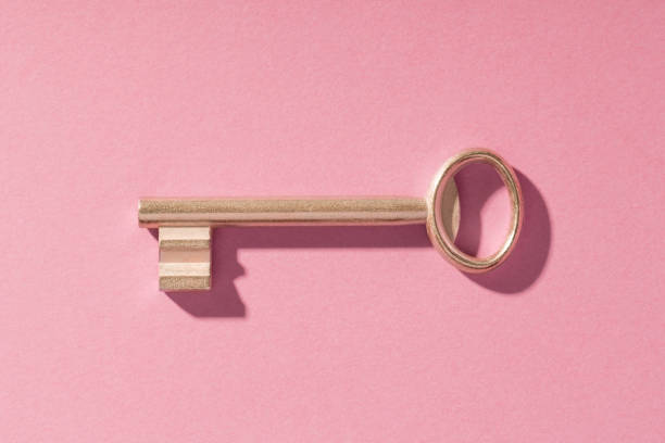 istock Gold classic key on pink background 1356929895