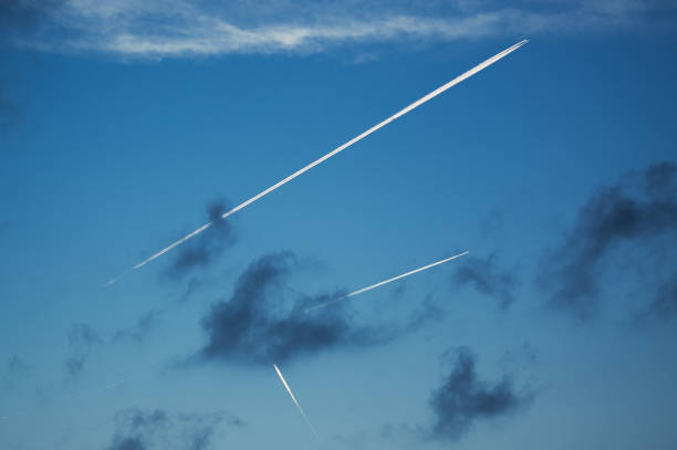 istock The contrails of several airplanes pervade the blue sky. 1356936863