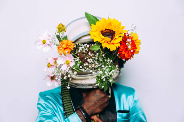 istock fine art concept with man wearing a space helmet and flowers composition 1356937113