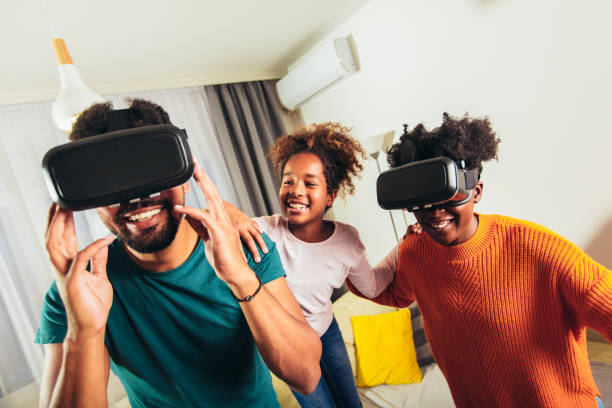 Family playing video games with VR glasses.
