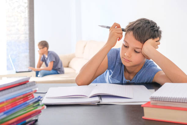 istock Kids doing school homework at home. Online learning, distance learning, homeschooling during quarantine, stay at home concept 1356939951