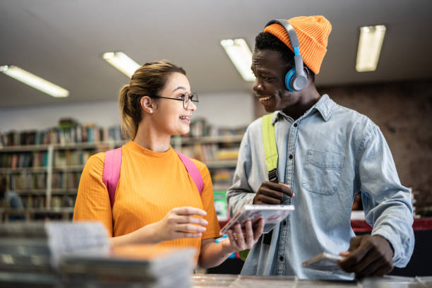 istock Friends browsing in a music store 1356940600